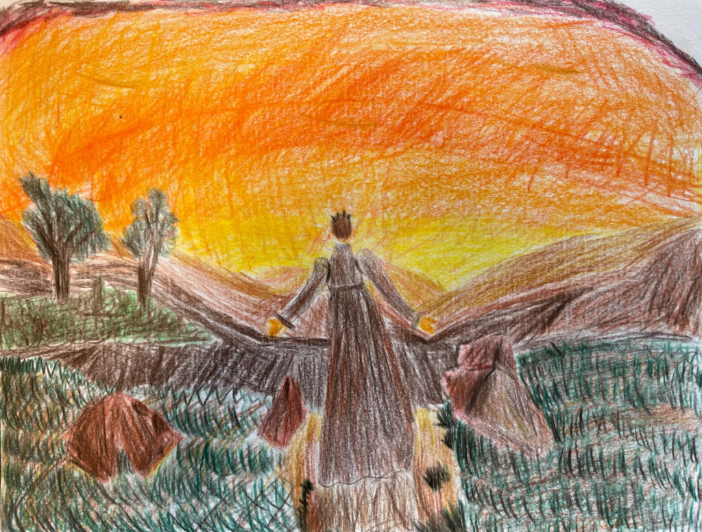 夕日の前に立つ女性